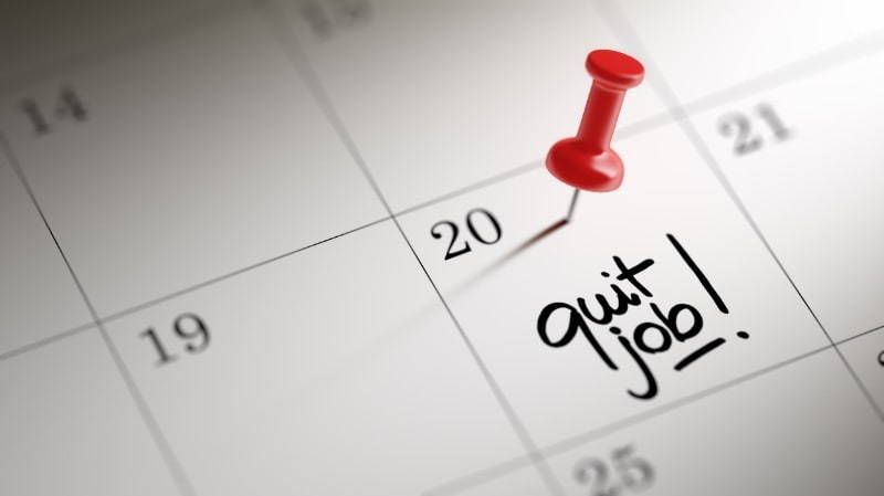 Calendar with "quit job" written in one back and pin on it
