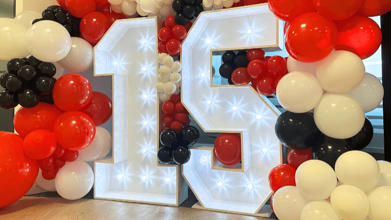 Large white 15 lights, with red white and black balloons